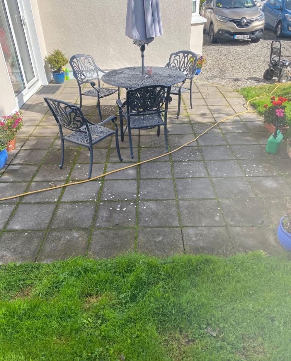 Patio before deep clean — moss and dirt between slabs